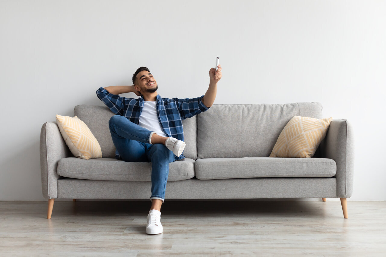 man turning on ac at home